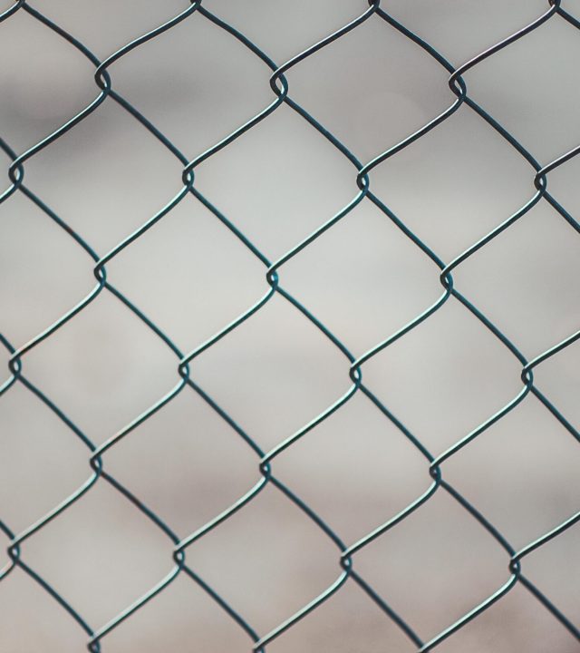 pexels-photo-683402-683402 Detailed closeup of a metal chain-link fence with a blurred neutral background, perfect for textures and overlays.